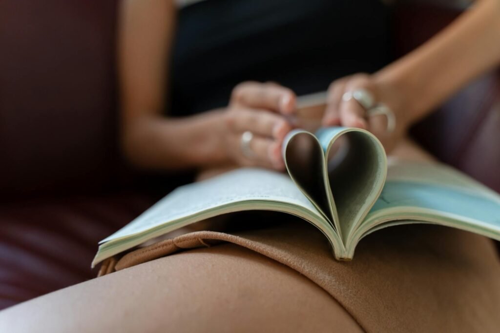 Person Folding Pages of an Open Book