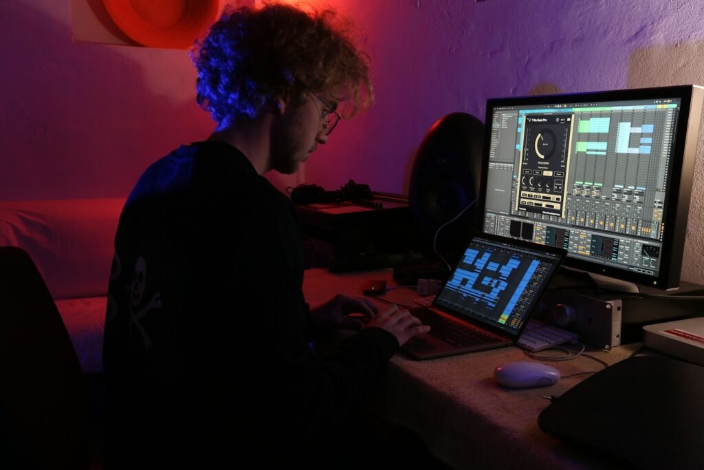 a man sitting in front of a computer monitor